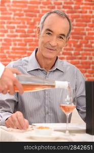 Man drinking wine in a restaurant