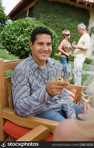 Man drinking wine in garden