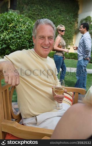 Man drinking wine in garden