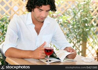 Man drinking wine on restaurant terrace