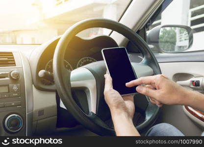 man driving car and using mobile phone