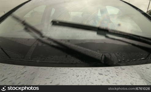 Man driving car on wet road in heavy rain PoV