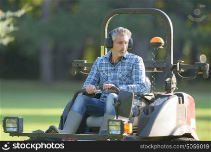 Man driving professional mower