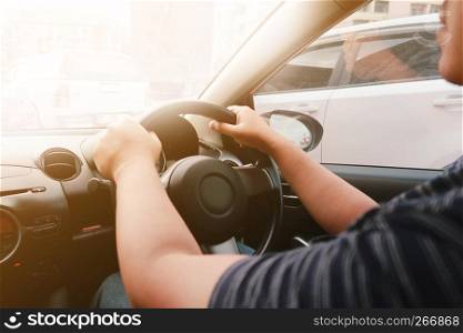 Man driving with both hands on steering wheel selective focus. safety driving concept