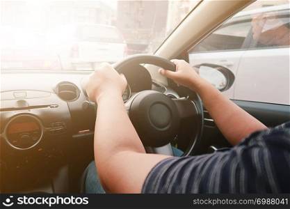 Man driving with both hands on steering wheel selective focus. safety driving concept