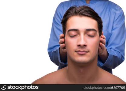 Man during massage session isolated on white