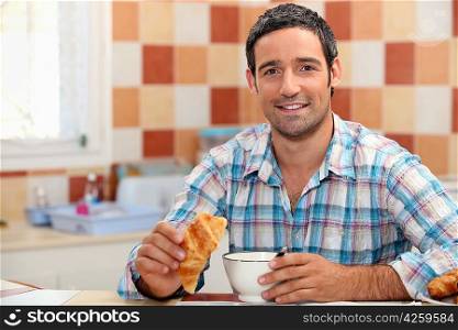Man eating a continental breakfast