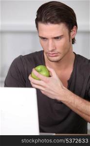 Man eating a green apple
