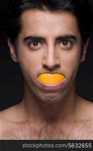 Man eating an orange