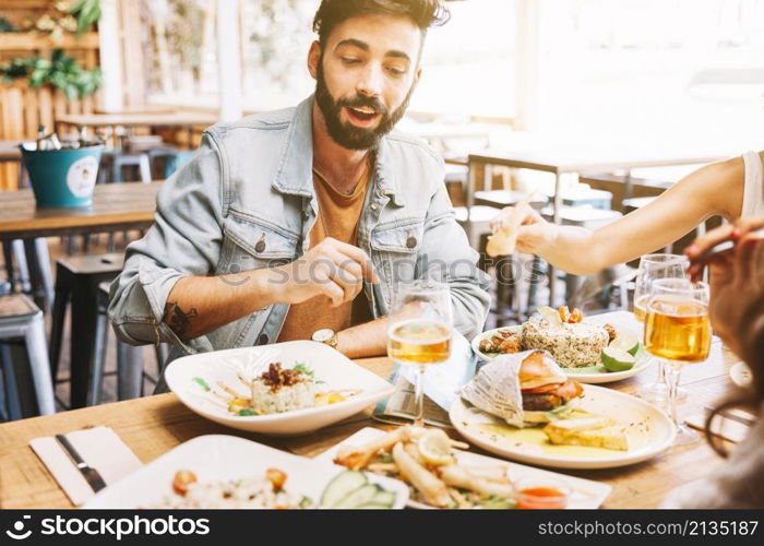 man eating different dishes food