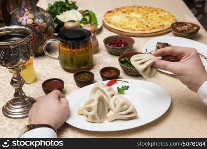 Man eating in georgian restaurant. Man eating in georgian restaurant with national dishes, pov view