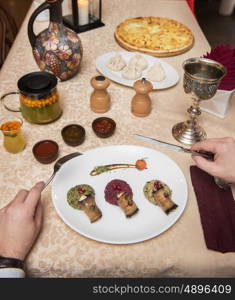 Man eating in georgian restaurant with national dishes, pov view