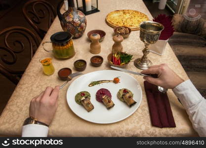 Man eating in georgian restaurant with national dishes, pov view