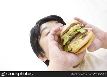 Man eating large burger