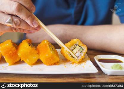 Man eating Maki Sushi