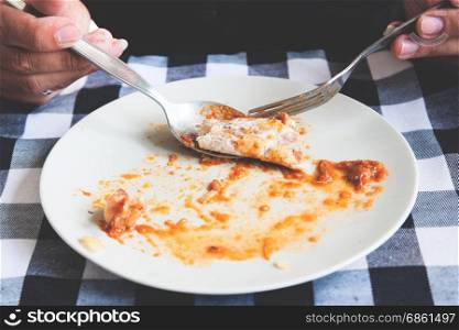 Man eating roti with traditional chicken curry