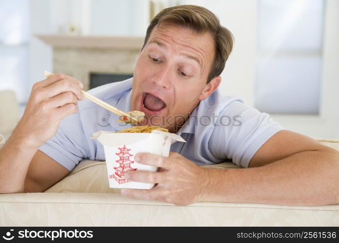 Man Eating Takeaways With Chopsticks