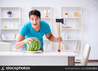 Man eating watermelon at home