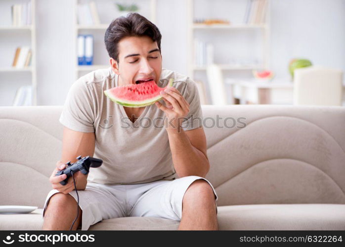 Man eating watermelon at home