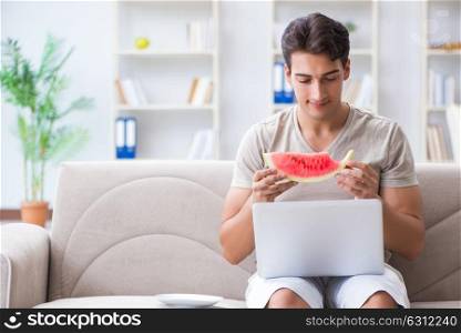 Man eating watermelon at home. The man eating watermelon at home