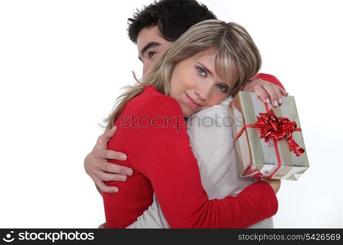 man embracing his girlfriend after giving her a present