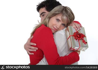 man embracing his girlfriend after giving her a present