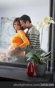 Man Embracing Pregnant Woman