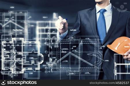 Man engineer at work. Male architect working with virtual construction plan