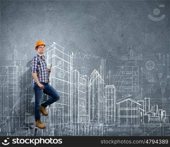 Man engineer. Image of man engineer against building project sketch