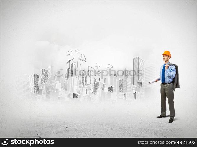 Man engineer. Image of man engineer in helmet with drafts. Construction concept