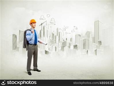 Man engineer. Image of man engineer in helmet with drafts. Construction concept