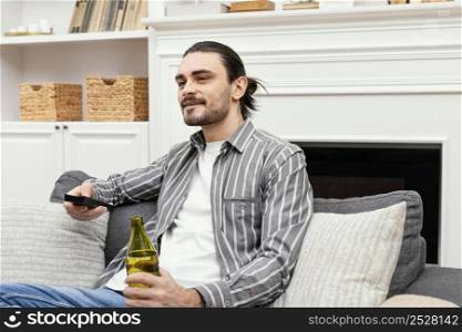 man enjoying beer watching tv