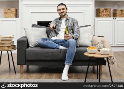 man enjoying beer watching tv sitting couch