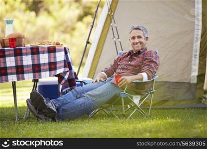 Man Enjoying Camping Holiday In Countryside
