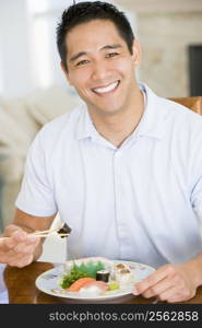 Man Enjoying Chinese Food With Chopsticks