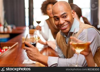 Man enjoying glass of wine and chatting