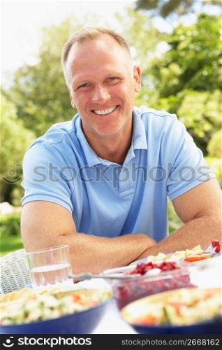 Man Enjoying Meal In Garden
