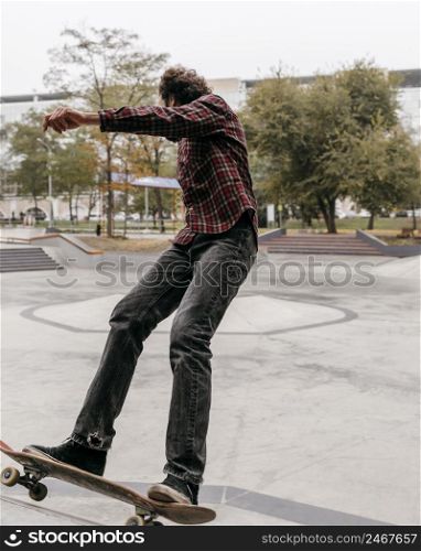 man enjoying skateboarding outdoors city park