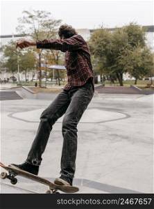 man enjoying skateboarding outdoors city park