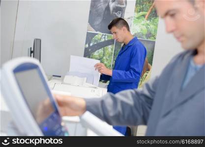 Man entering information on to control pad