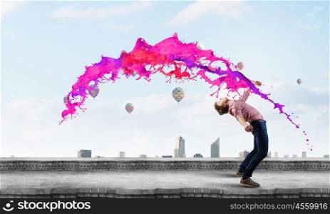 Man evades light. Young guy in casual evading from colorful splashes