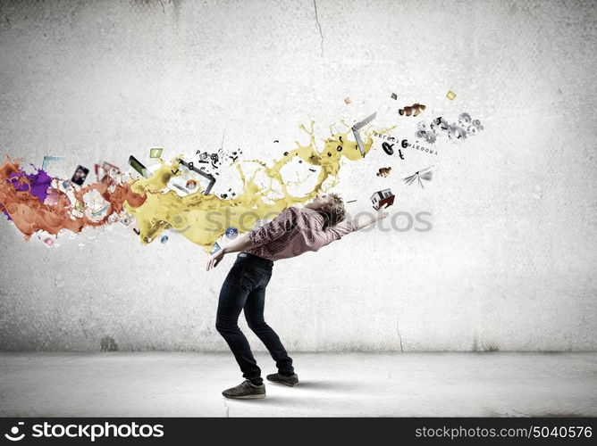 Man evades light. Young guy in casual evading from colorful splashes