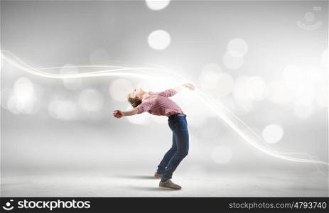 Man evades light. Young guy in casual evading from light rays