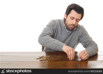 Man examines coins on a desk, isolated