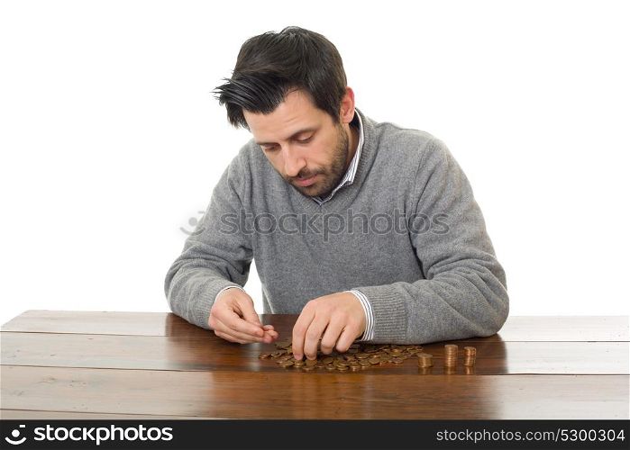 Man examines coins on a desk, isolated