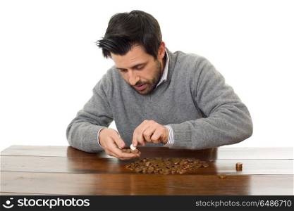 Man examines coins on a desk, isolated. numismatist