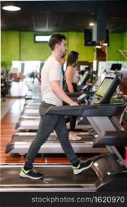 Man exercising cardio, running workout on treadmill at fitness gym. High quality photo. Man exercising cardio, running workout on treadmill at fitness gym. 