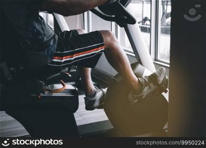 Man exercising in fitness with exercise bike