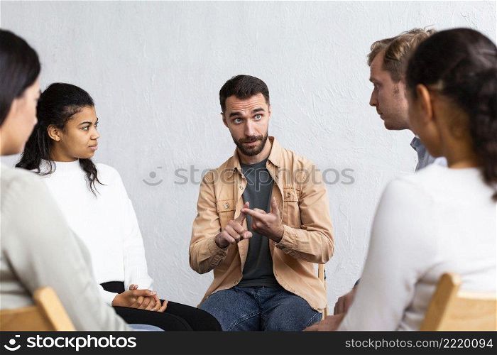 man explaining his problems group therapy session