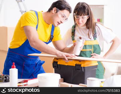 Man explaining woman woodworking tips in wood workshop. The man explaining woman woodworking tips in wood workshop